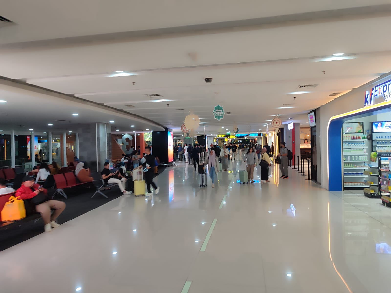 Passengers at Ngurah Rai Airport pass by.