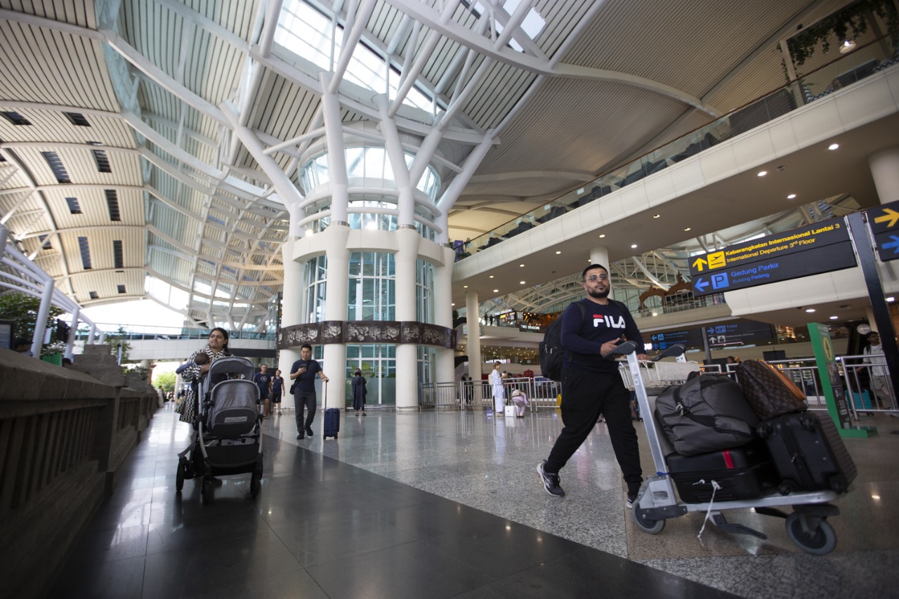 I Gusti Ngurah Rai Airport Bali international arrivals area showing the rapid 12.4% growth in foreign tourist numbers during 2025.