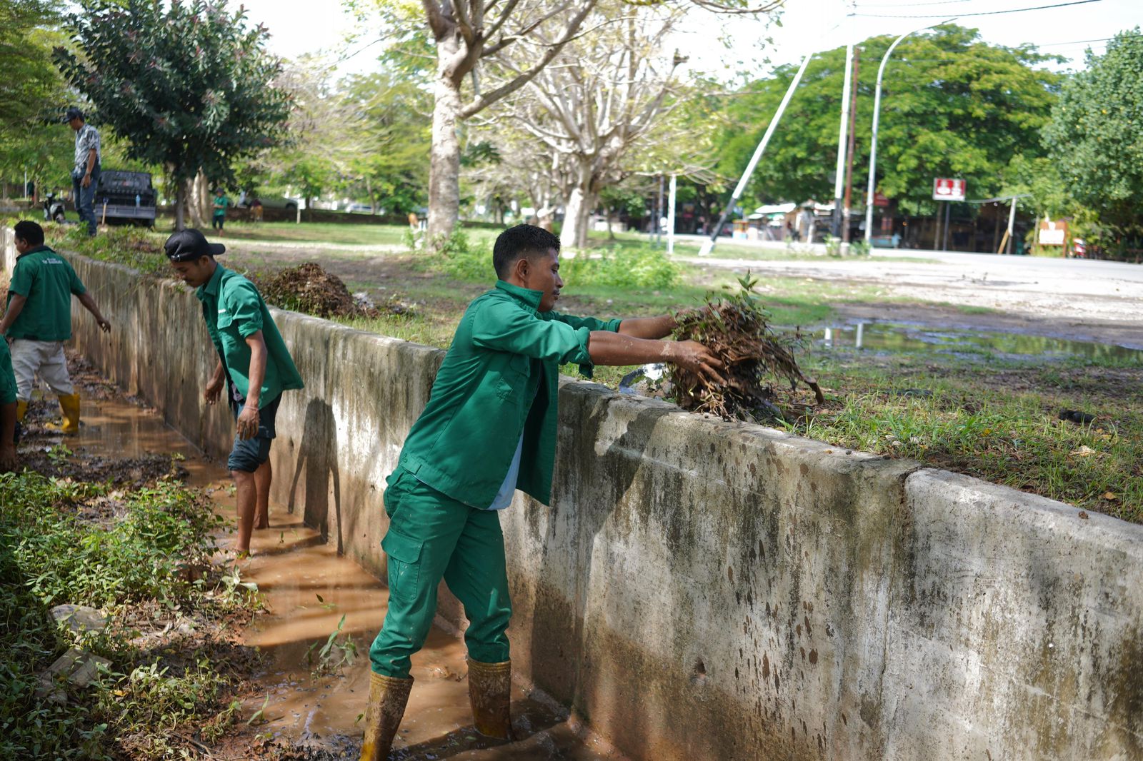 Heavy equipment clearing mud and trash from a drainage channel in the Mandalika Special Economic Zone.